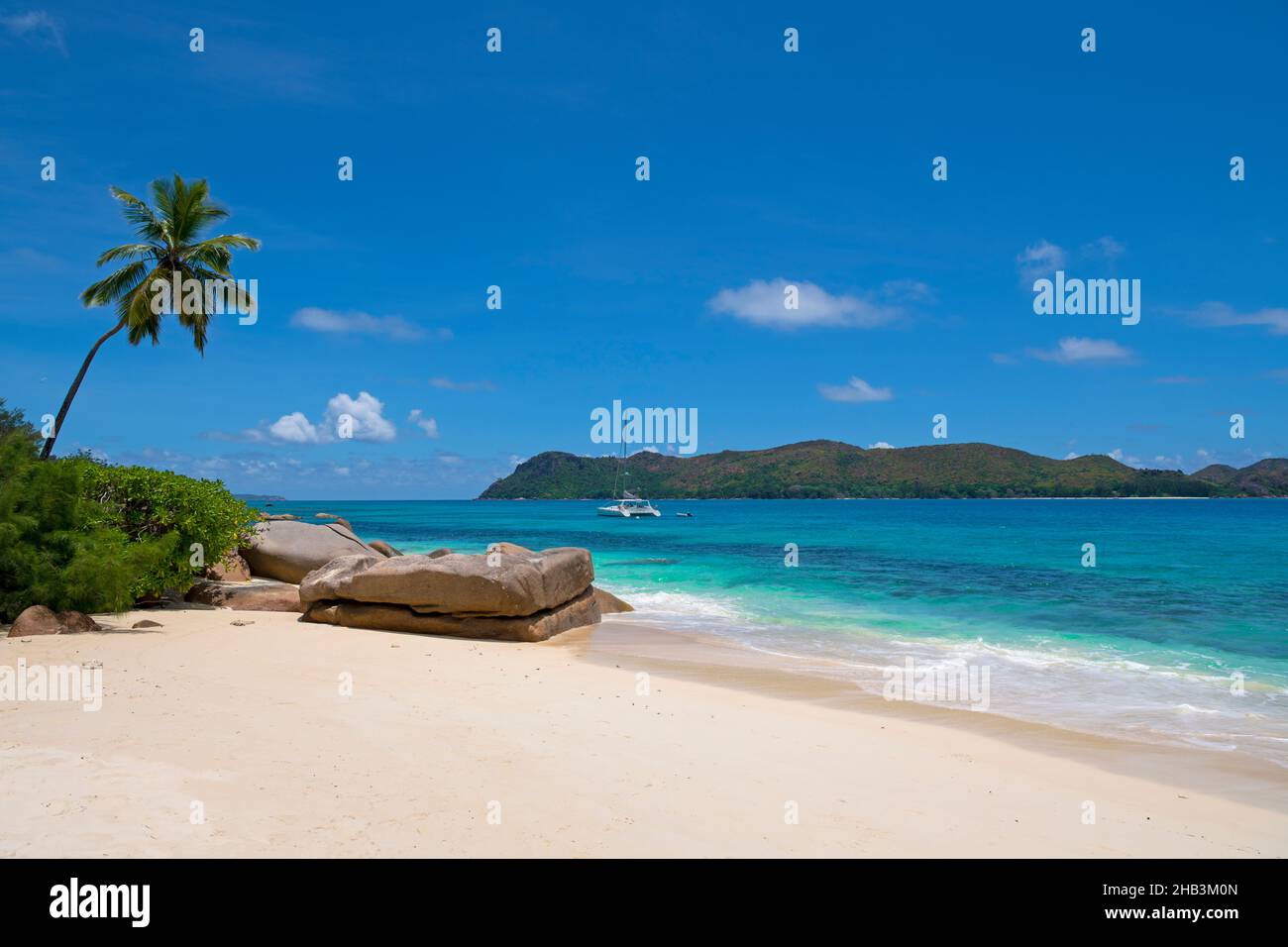 Secluded pristine beach with Curieuse Island Anse Pasquiere Praslin Seychelles Stock Photo