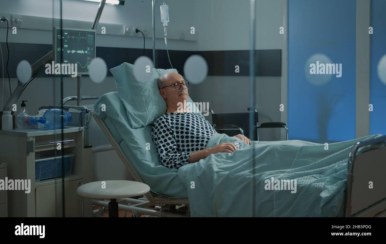 Sick patient sleeping in hospital ward bed at health facility with