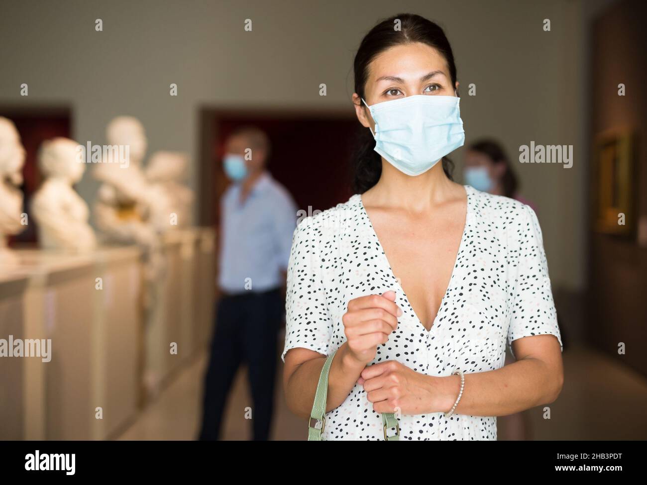 Woman standing in museum hall Stock Photo