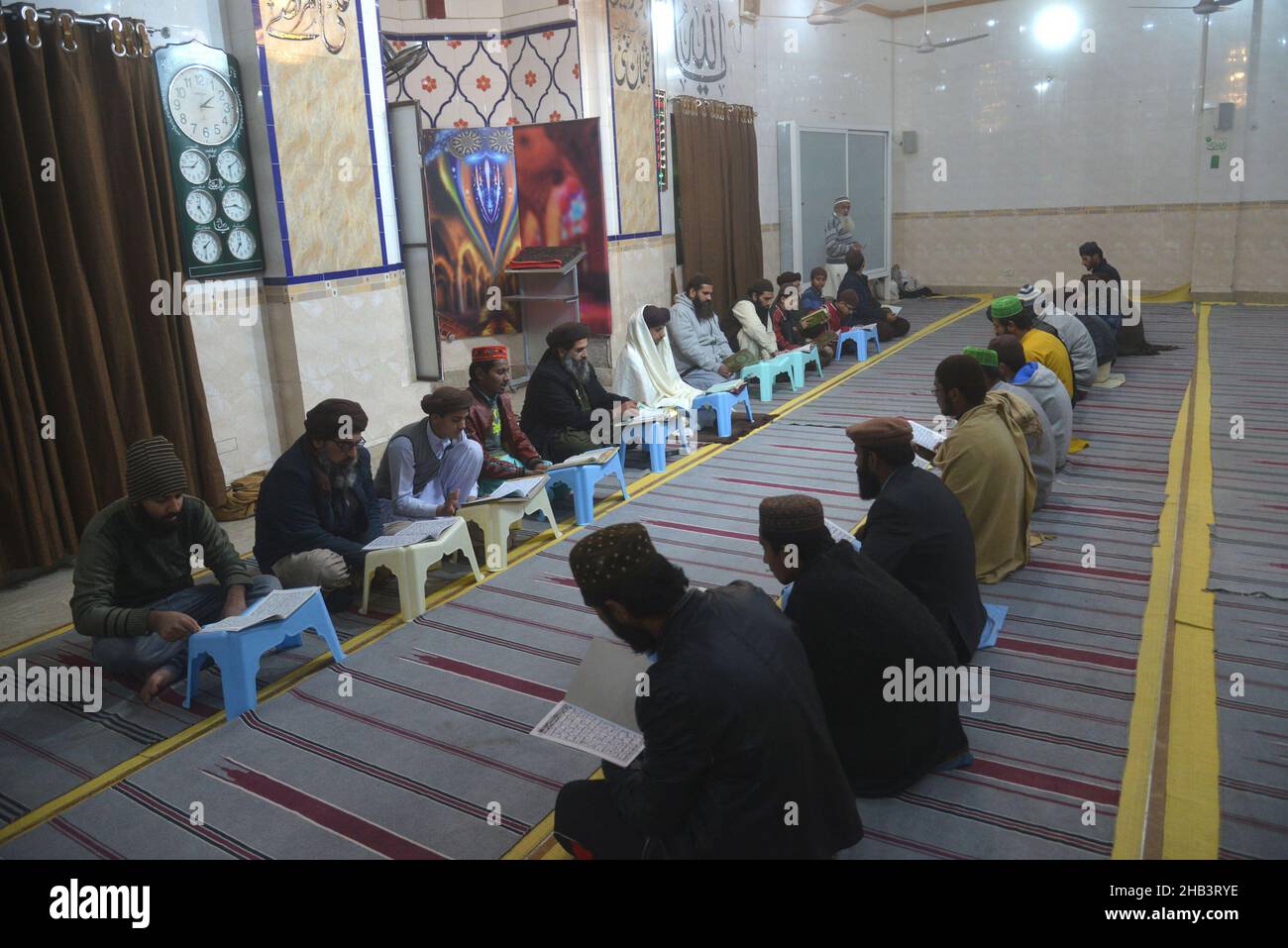 Lahore, Pakistan. 16th Dec, 2021. Leader of Tehreek Labbaik Pakistan (TLP) Hafiz Saad Hussain Rizvi, Hafiz Anas Hussain Rizvi and students are reciting holy Quran, offering prayer during in the remembrance of the Martyrs Teachers and Students of Army Public School (APS) Peshawar incident, at Masjid Rehmat ul lil Alameen in Lahore. An attack on the Army Public School (APS) in the city of Peshawar, where more than 150 students were killed when Taliban gunmen overran. (Photo by Rana Sajid Hussain/Pacific Press) Credit: Pacific Press Media Production Corp./Alamy Live News Stock Photo