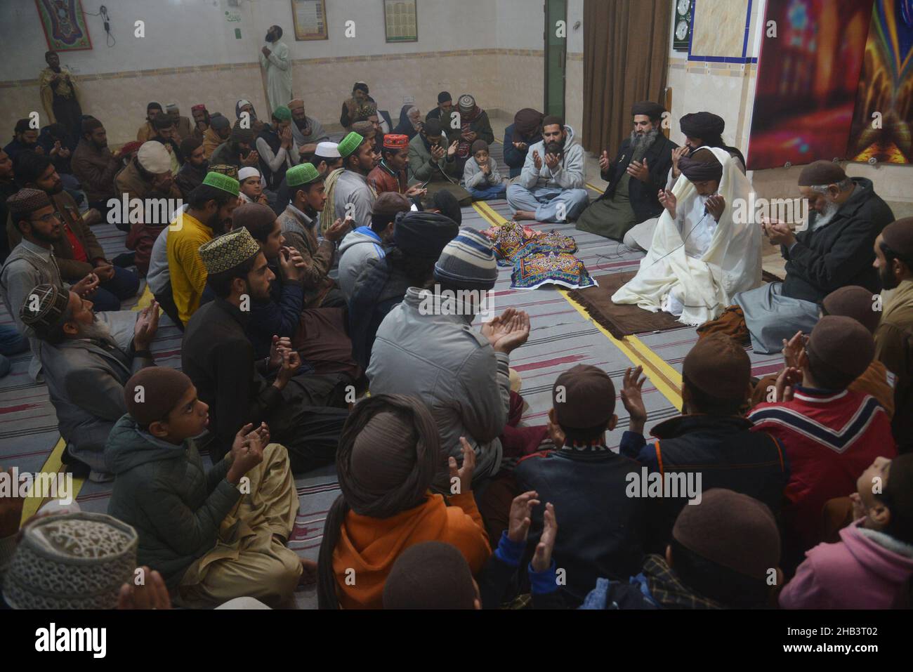 Lahore, Pakistan. 16th Dec, 2021. Leader of Tehreek Labbaik Pakistan (TLP) Hafiz Saad Hussain Rizvi, Hafiz Anas Hussain Rizvi and students are reciting holy Quran, offering prayer during in the remembrance of the Martyrs Teachers and Students of Army Public School (APS) Peshawar incident, at Masjid Rehmat ul lil Alameen in Lahore. An attack on the Army Public School (APS) in the city of Peshawar, where more than 150 students were killed when Taliban gunmen overran. (Photo by Rana Sajid Hussain/Pacific Press) Credit: Pacific Press Media Production Corp./Alamy Live News Stock Photo