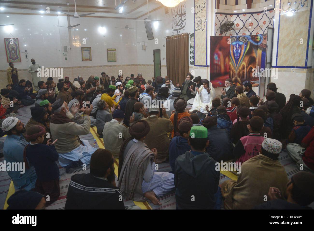 Lahore, Punjab, Pakistan. 16th Dec, 2021. Leader of Tehreek Labbaik Pakistan (TLP) Hafiz Saad Hussain Rizvi, Hafiz Anas Hussain Rizvi and students are reciting holy Quran, offering prayer during in the remembrance of the Martyrs Teachers and Students of Army Public School (APS) Peshawar incident, at Masjid Rehmat ul lil Alameen in Lahore. An attack on the Army Public School (APS) in the city of Peshawar, where more than 150 students were killed when Taliban gunmen overran. (Credit Image: © Rana Sajid Hussain/Pacific Press via ZUMA Press Wire) Stock Photo