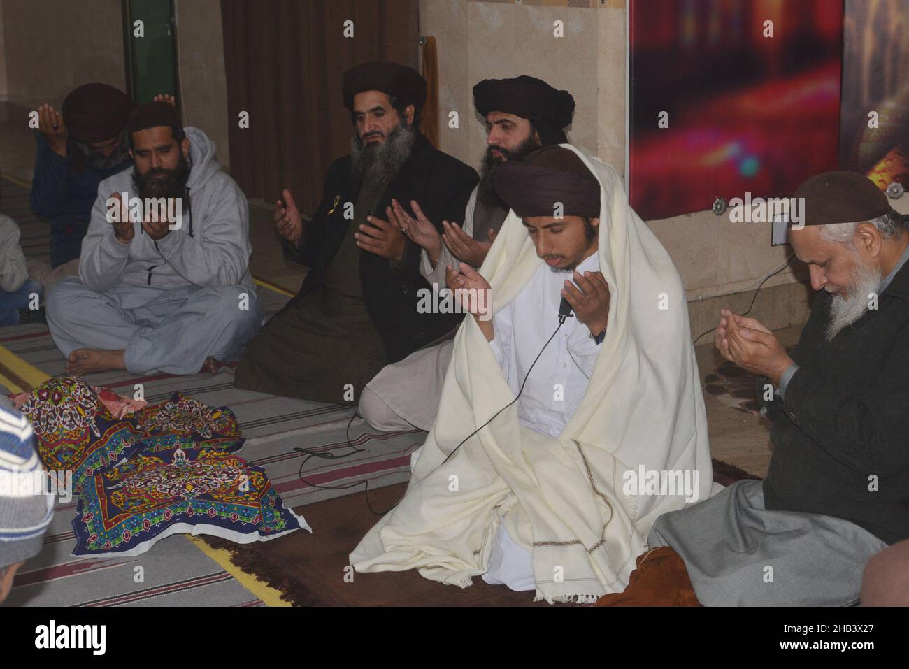 Lahore, Punjab, Pakistan. 16th Dec, 2021. Leader of Tehreek Labbaik Pakistan (TLP) Hafiz Saad Hussain Rizvi, Hafiz Anas Hussain Rizvi and students are reciting holy Quran, offering prayer during in the remembrance of the Martyrs Teachers and Students of Army Public School (APS) Peshawar incident, at Masjid Rehmat ul lil Alameen in Lahore. An attack on the Army Public School (APS) in the city of Peshawar, where more than 150 students were killed when Taliban gunmen overran. (Credit Image: © Rana Sajid Hussain/Pacific Press via ZUMA Press Wire) Stock Photo