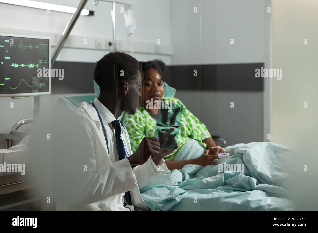 African american therapist doctor monitoring patient explaining bones ...