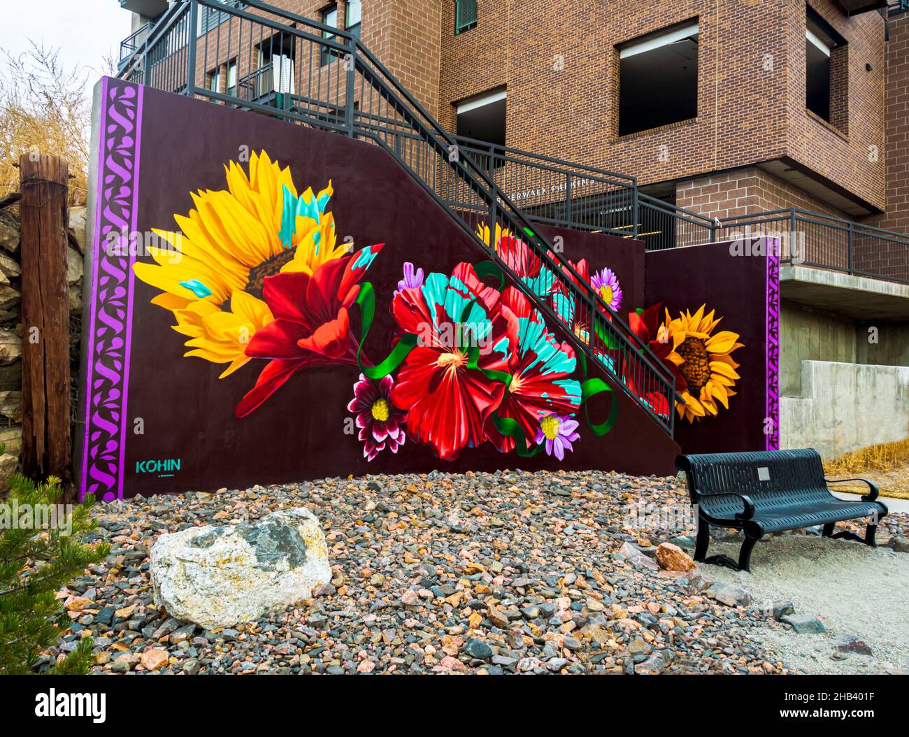 Colorful flowers of outdoor mural display created by artist Dan Toro on stairway near the River Walk parking area, downtown Castle Rock Colorado USA. Stock Photo