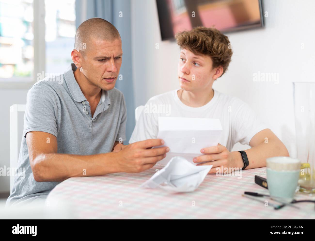 Son and his father reading letter Stock Photo