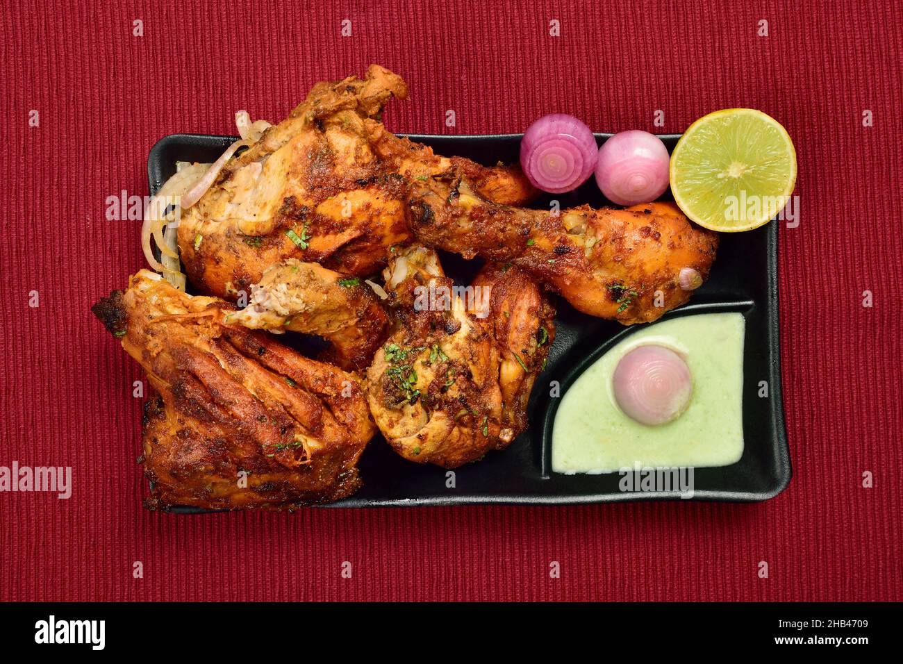 Top View of Tandoori Chicken with Onion Chutney and Lemon in Plate, Famous Indian Food Tandoori Murg Stock Photo