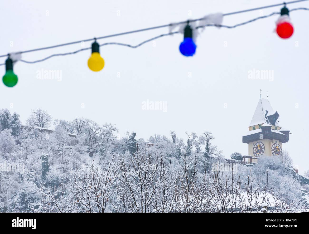 The famous clock tower on Schlossberg hill, in Graz, Steiermark region, Austria, with snow, in winter. Selective focus Stock Photo