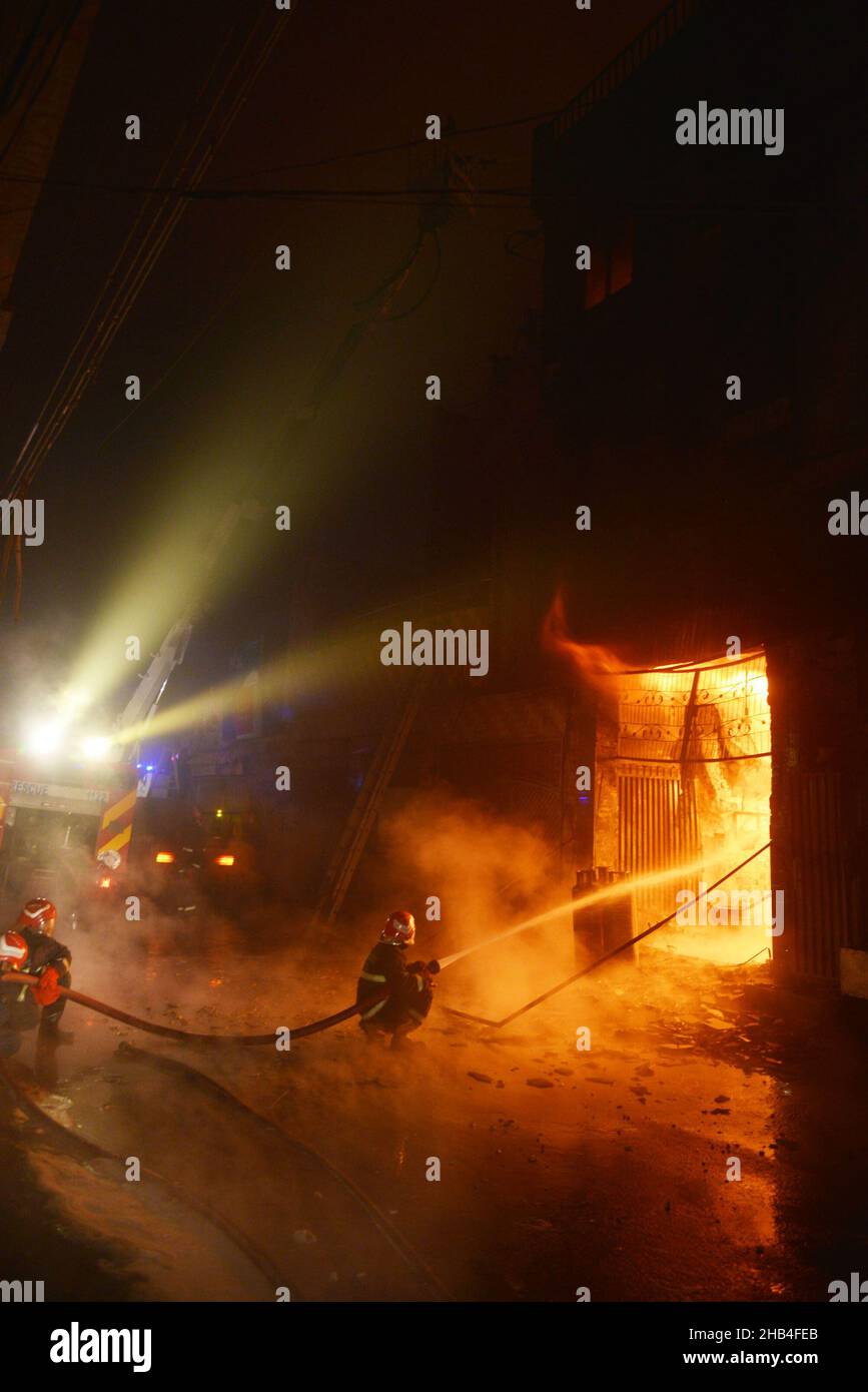 Lahore, Punjab, Pakistan. 15th Dec, 2021. Pakistani rescue 1122 Firefighters try to extinguish a fire that erupted in a Gas Calendar factory at Shalamar Garden area in Provincial Capital city Lahore, at least two persons killed and several injured shifted to near hospital. (Credit Image: © Rana Sajid Hussain/Pacific Press via ZUMA Press Wire) Stock Photo