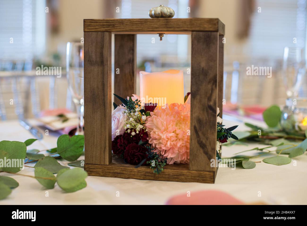 Square wood candle lantern centerpiece at wedding reception Stock Photo