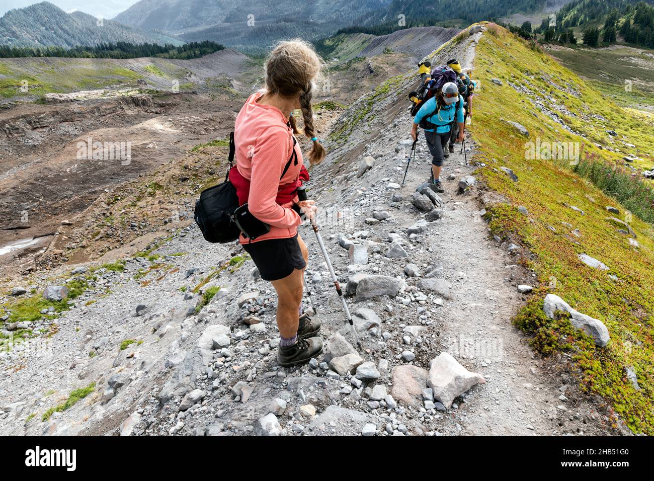 WA20541-00....WASHINGTON -Day hiker and backpackers pass each other along the Railroad Grade Trail in the Mount Baker National Recreation Area. Stock Photo