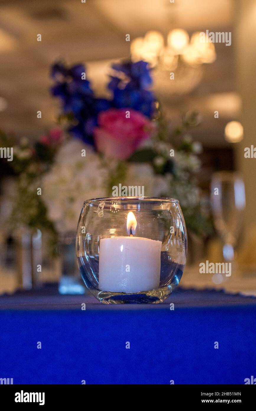 Glass round candle holder with lit white candle Stock Photo Alamy