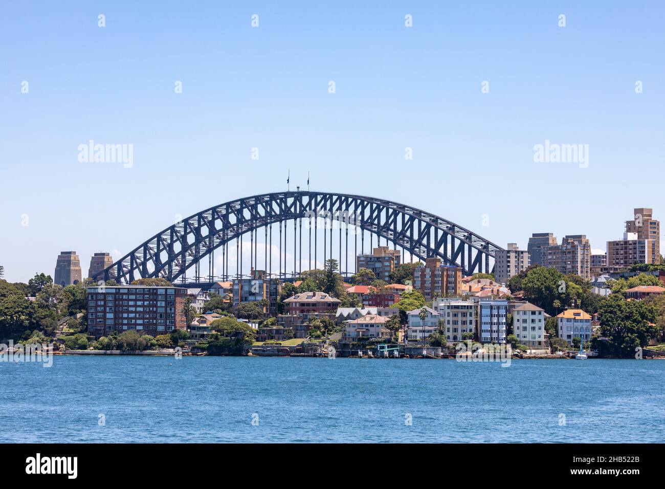 Sydney Harbour Bridge viewed from Cremorne Point and waterfront homes in Kirribilli, Sydney,NSW,Australia Stock Photo