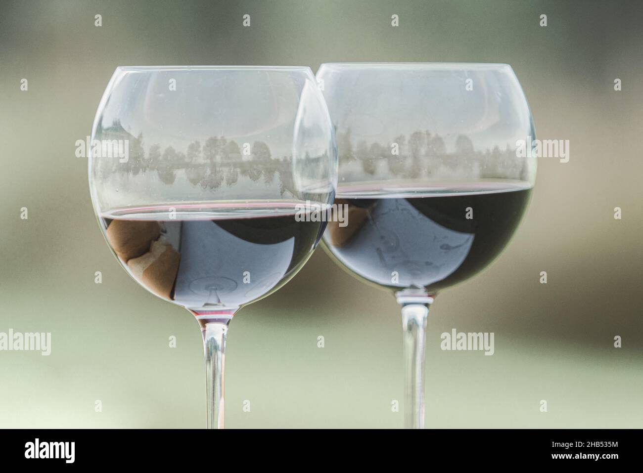 Breaking bread wedding ceremony filled wine glasses outdoors Stock