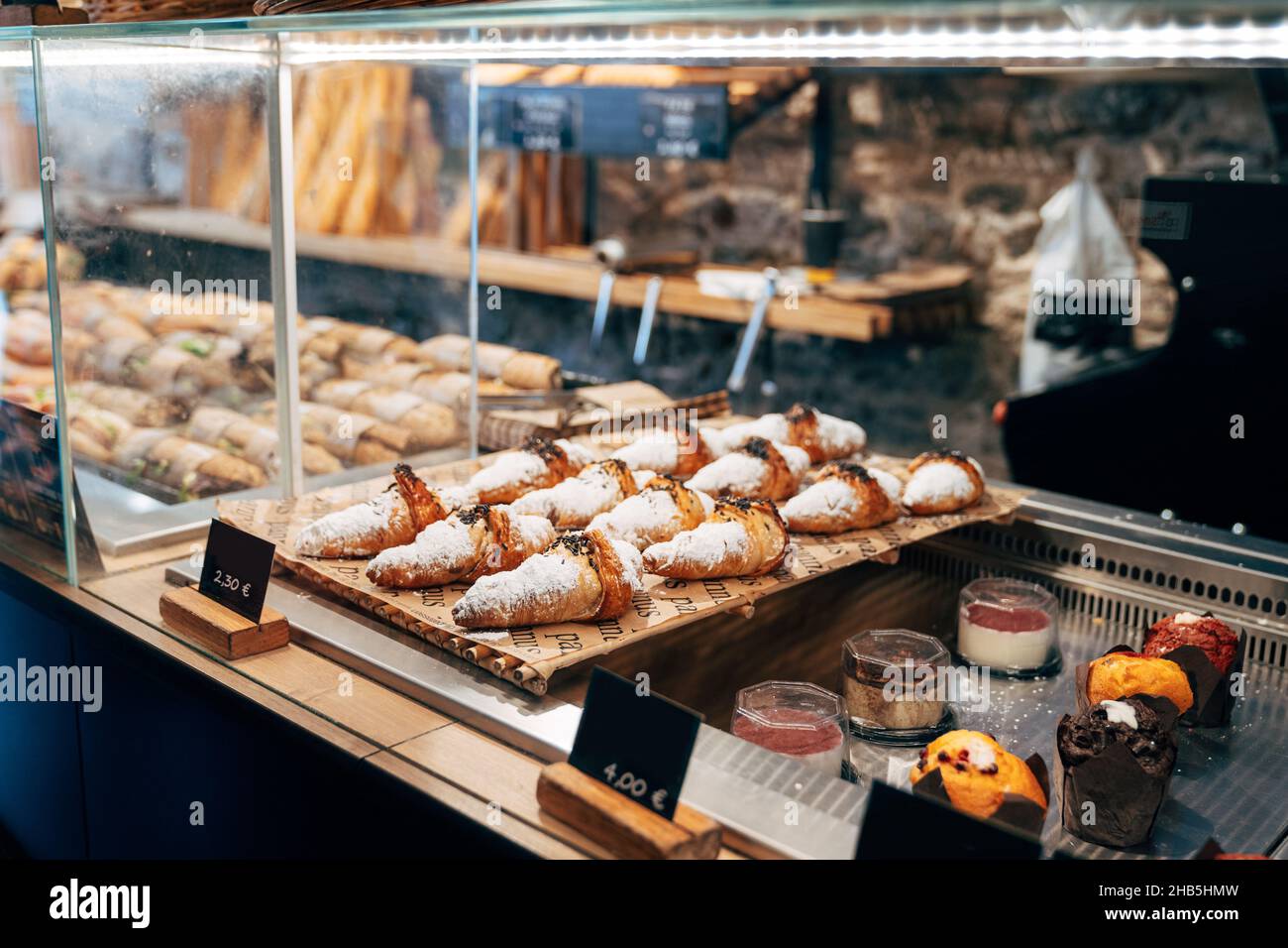 Various cakes are on plates in a display case Stock Photo