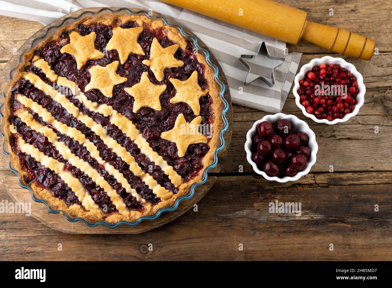 After baking. Homemade cherry pie. Cake from dough with stars. Food for 4th July USA Independence Day. American Pie. Sweet pastries. Berry tart. DIY. Step by step instruction Stock Photo