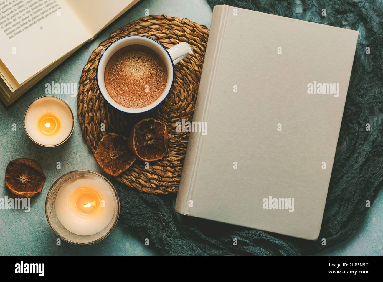Top view of books and cup of coffee with candles on a table. Selective focus Stock Photo