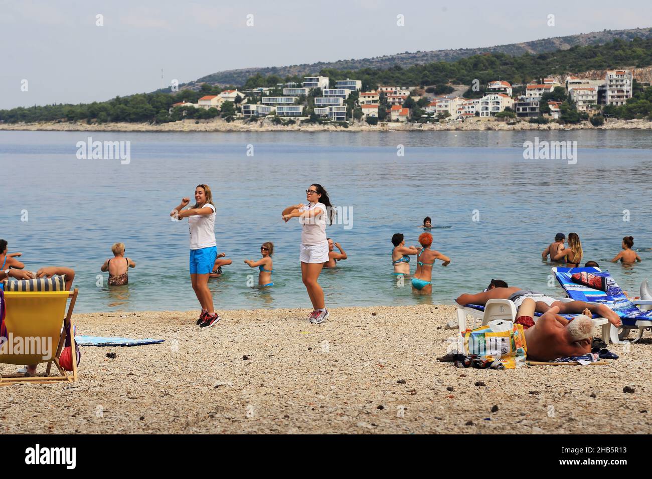 PRIMOSTEN, CROATIA - SEPTEMBER 10, 2016: Unidentified animators play an aerobics class on the beach. Stock Photo