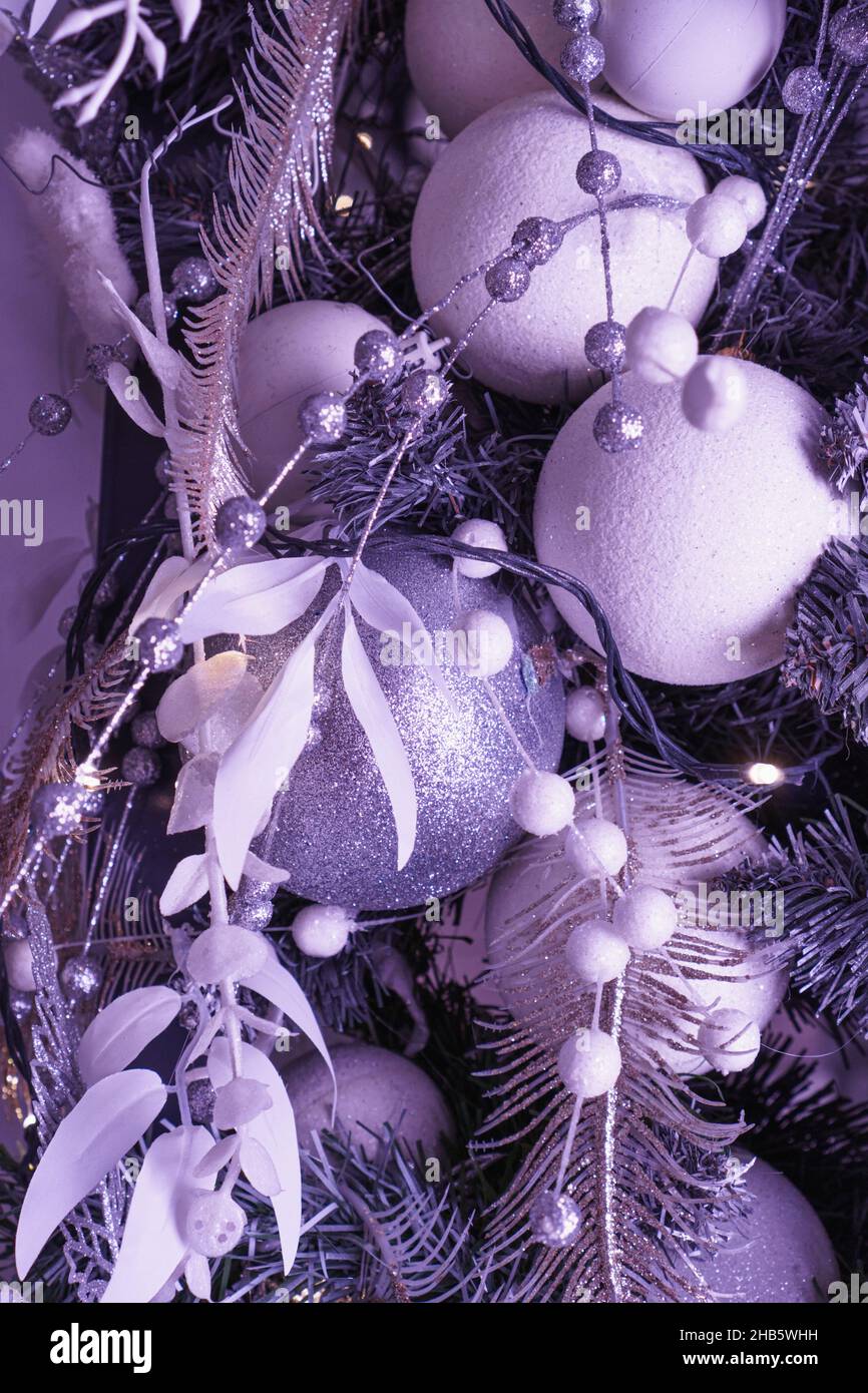 Numerous decorative tinsels on Christmas tree in violet tone. Color of 2022. Very Peri pantone Stock Photo