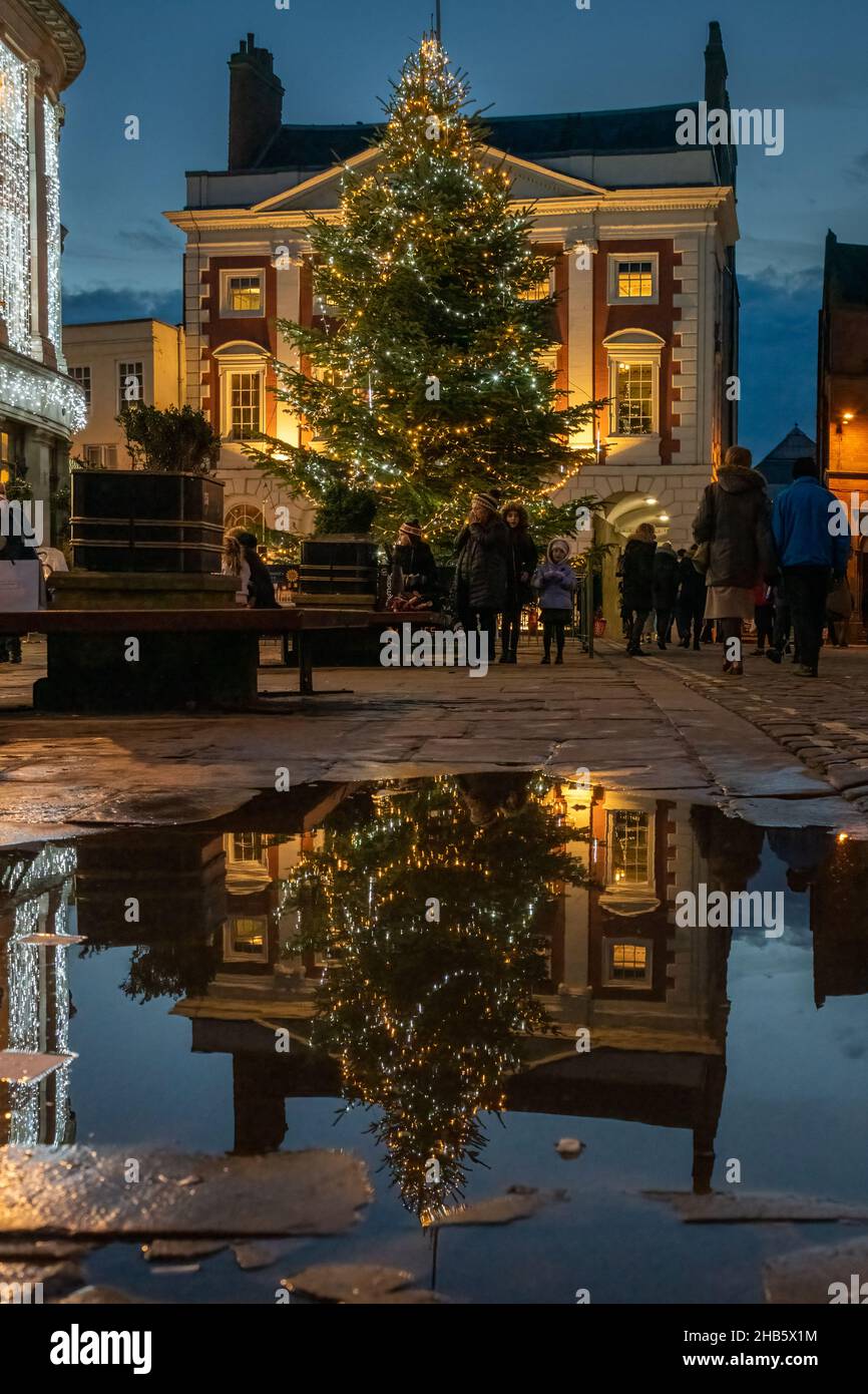 Decorative Christmas Tree Reflected in Puddle in York, UK Stock Photo