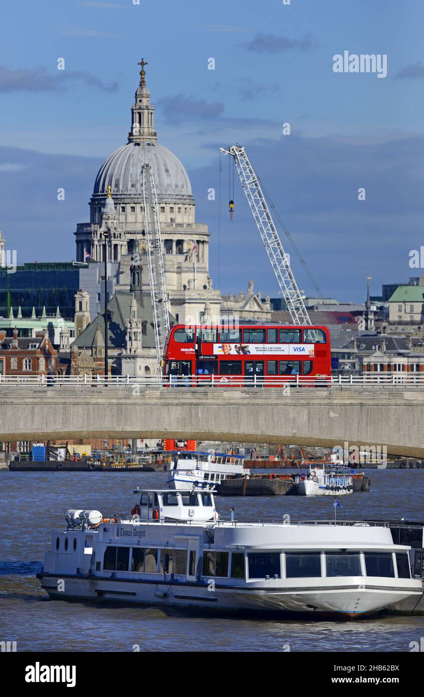 London, England, UK. View of St Paul's Cathedral, the M.V. Thomas Doggett tourist boat on the River Thames and a bus crossing Waterloo Bridge, seen fr Stock Photo