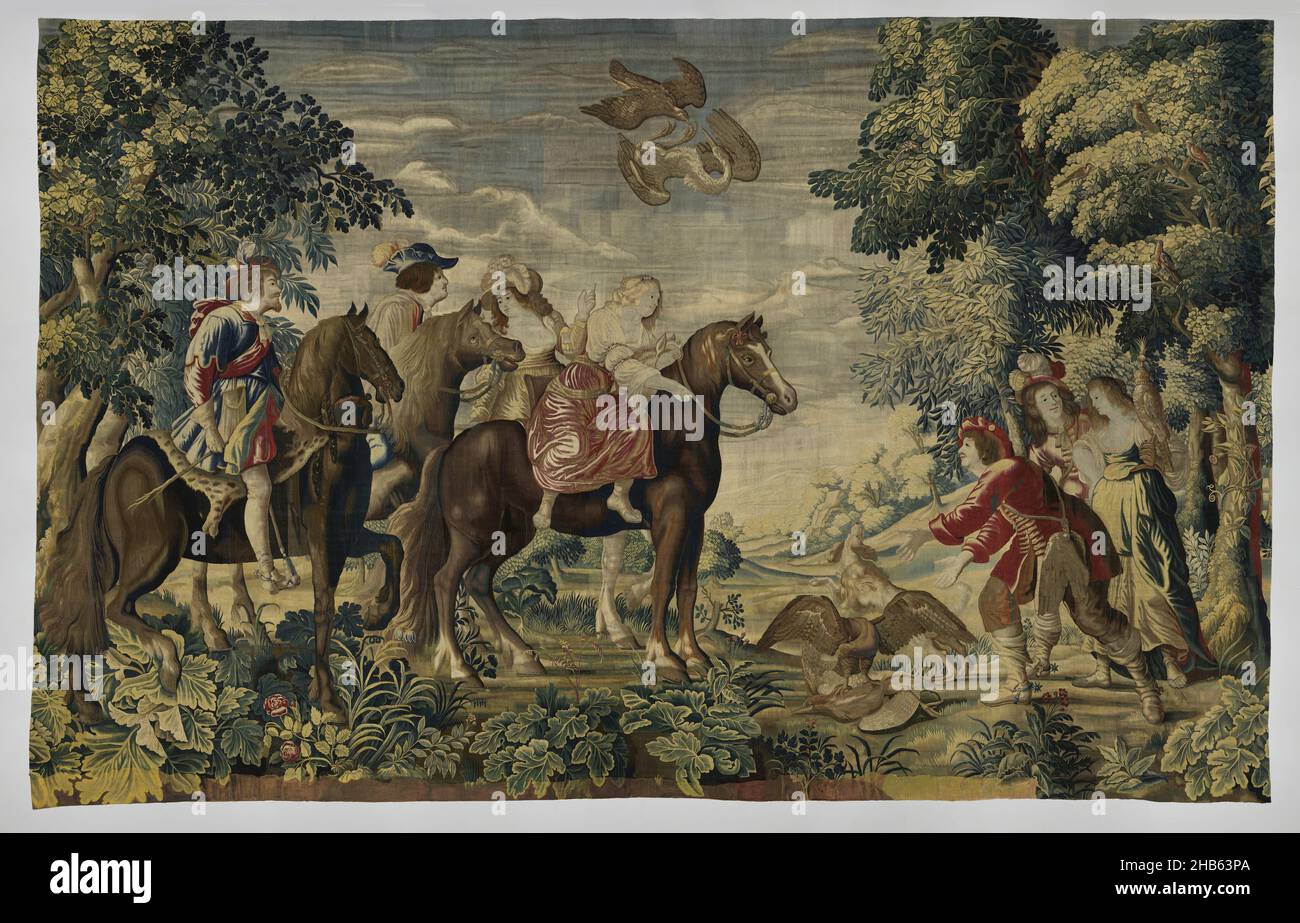 Falcon Hunt, The English Yachts (series title), Tapestry with Falcon Hunt: in the foreground four horsemen looking to the right. The front two horses, a blaze and a grey, are ridden by amazons; two dark horses by riders. In front of them is a heron on which a falcon stands with averted spread wings. A dog looks up at a heron in the air that is falling down under a shooting falcon. On the right are two men and a woman with flat. The scene is seen in a forest landscape with vistas in the center and tall trees on the sides, while the foreground is filled with large-flowered flowering plants Stock Photo