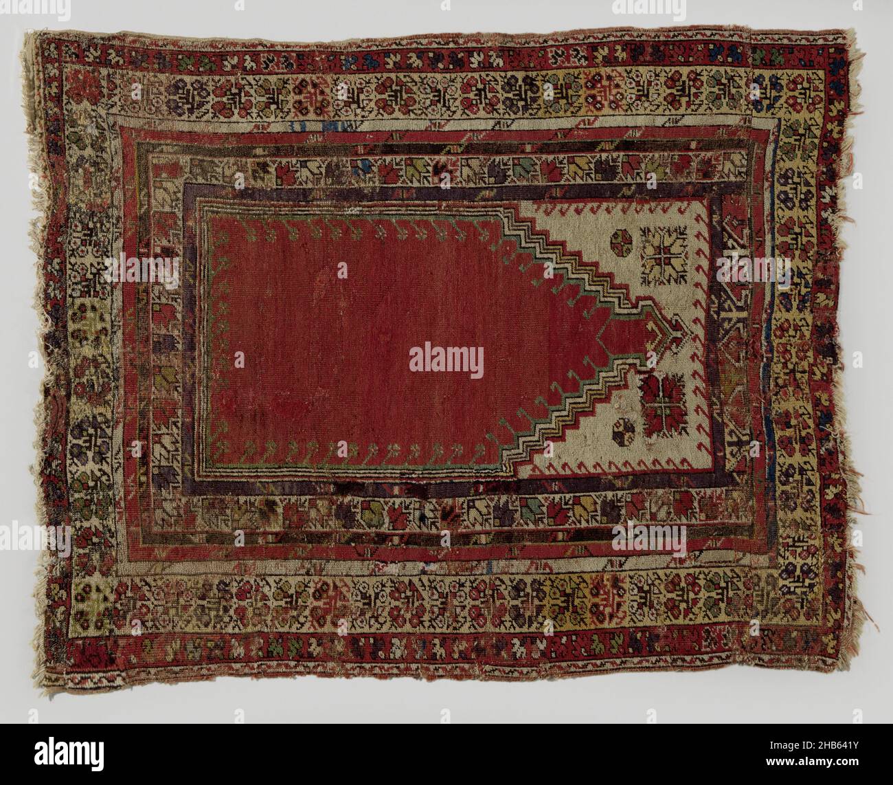 Prayer rug, Prayer rug, stepped mirab on red fond, yellow and red borders., maker: anonymous, Centraal-Klein-Azië, 1800 - 1900, wool, height 158 cm × width 125 cm Stock Photo
