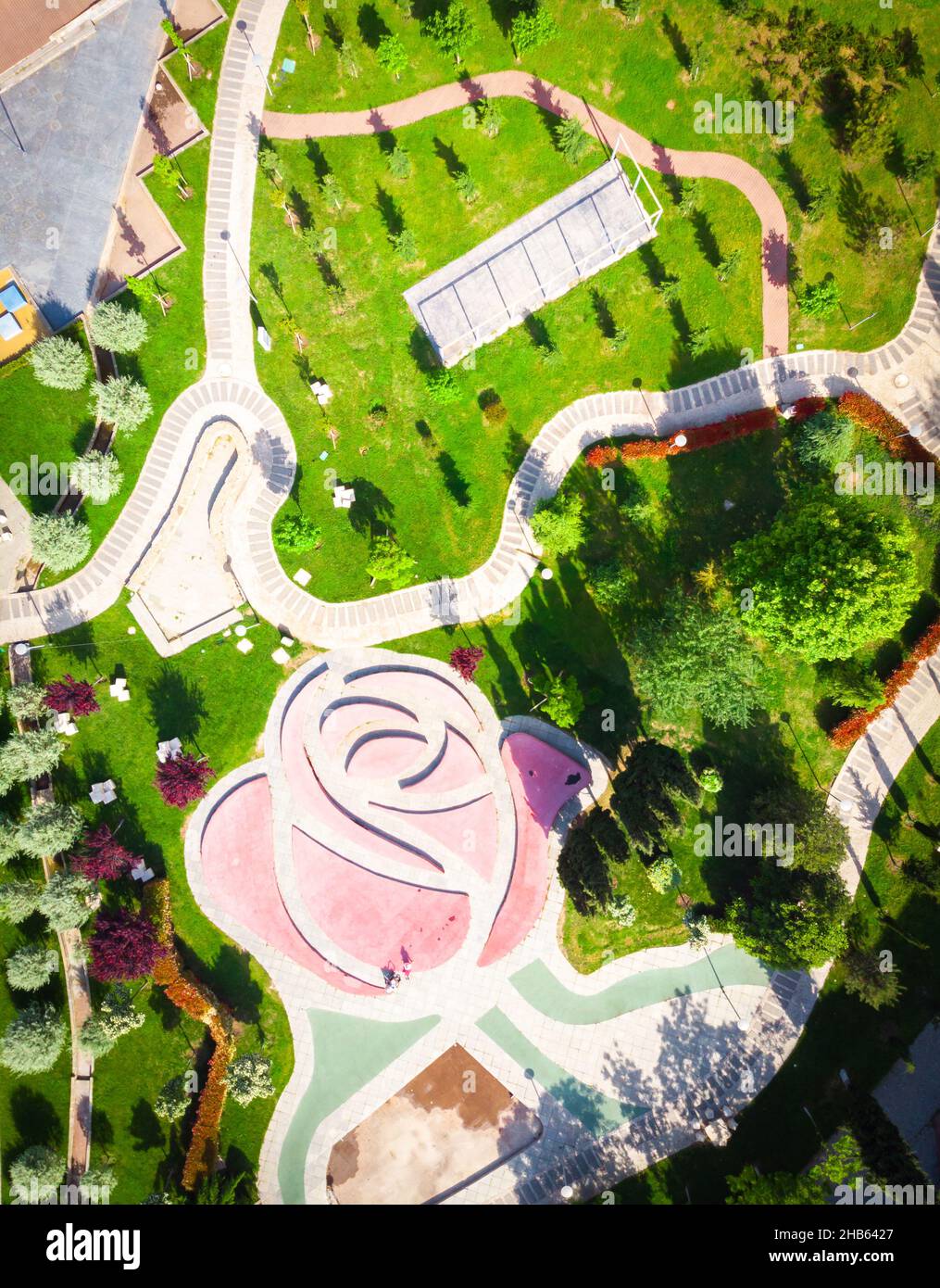 Rike park with blooming spring nature and playground. Aerial view down ...