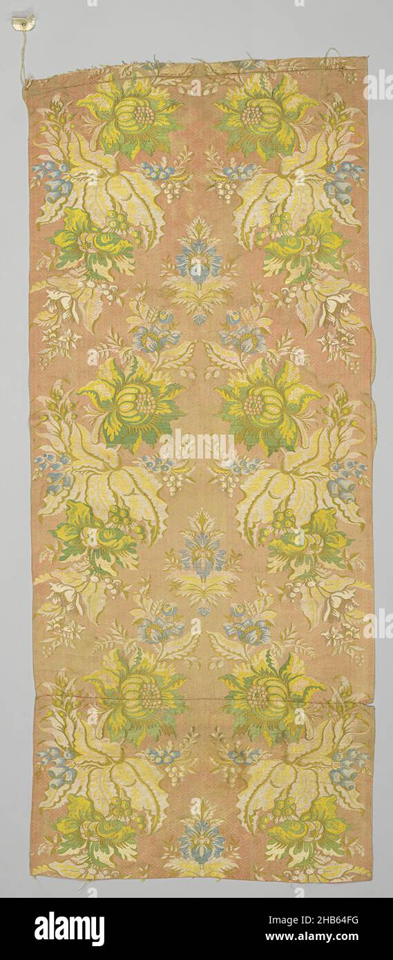 Job of two silk fabrics sewn together with floral design, Job of two silk fabrics launched and brocaded together, canntillé, liseré. Dessin: pairs of facing very large-scale arrangements of flowers and leaves between which there is a central, smaller, symmetrically constructed floral arrangement in yellow, mustard, green and two colors of blue (brocade) and écru (launch) on pink fond with liseré effect in beige. Labeled at top with 22576 Rose ground Brocade 1 1/3 yrds 35.00 yards. On reverse side on fabric scribed: 22576. Pinned paper with letter Z. Condition: good, mat somewhat worn., France Stock Photo