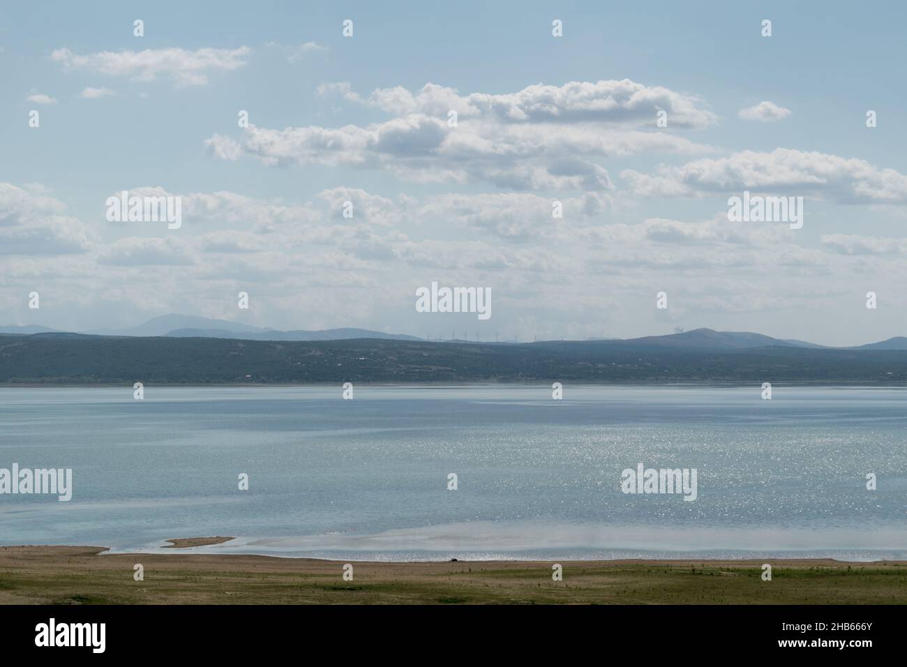 The landscape of Busko Lake in summer with low water levels and mountains in the background Stock Photo