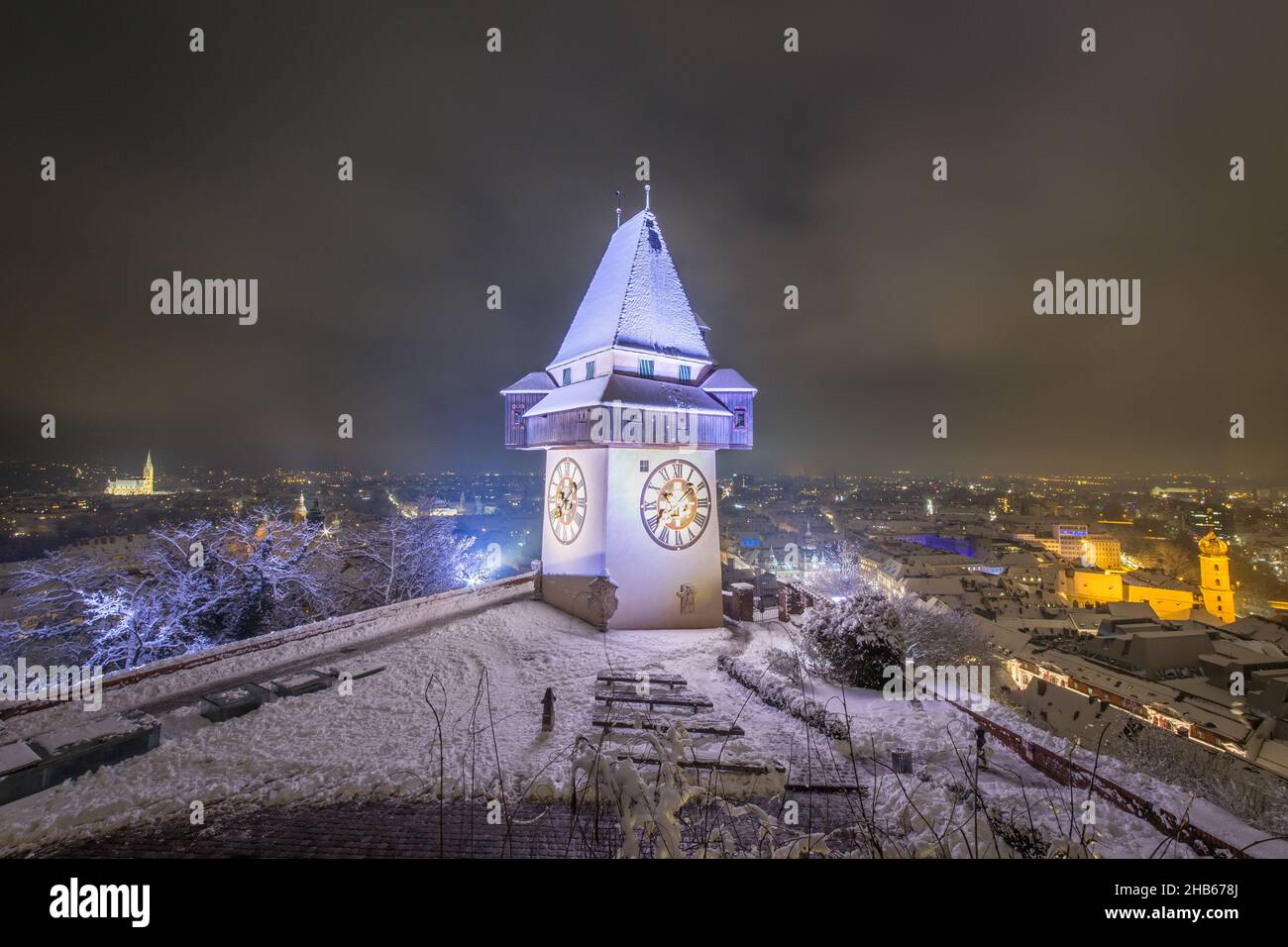 The snowy Uhrturm at the Schossberg hill in the middle of Graz Stock Photo