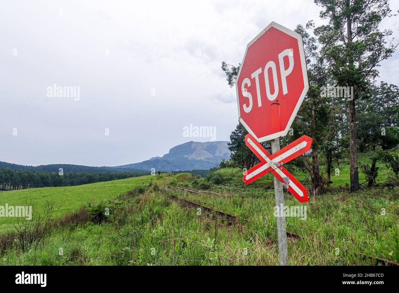 STOP sign and railway crossing at the abandoned Mac Mac station, Mpumalanga, South Africa Stock Photo