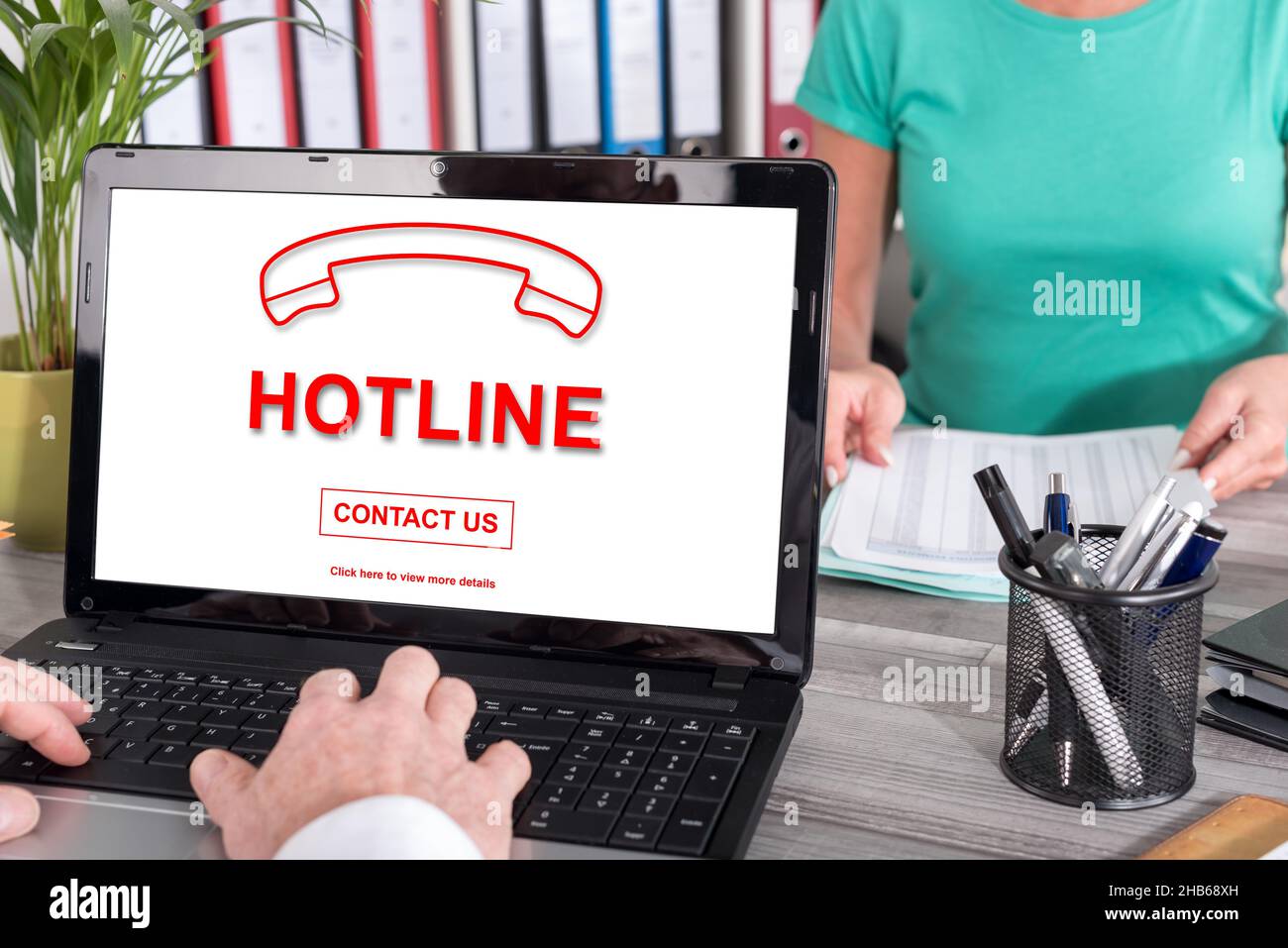 Laptop screen with hotline concept Stock Photo - Alamy