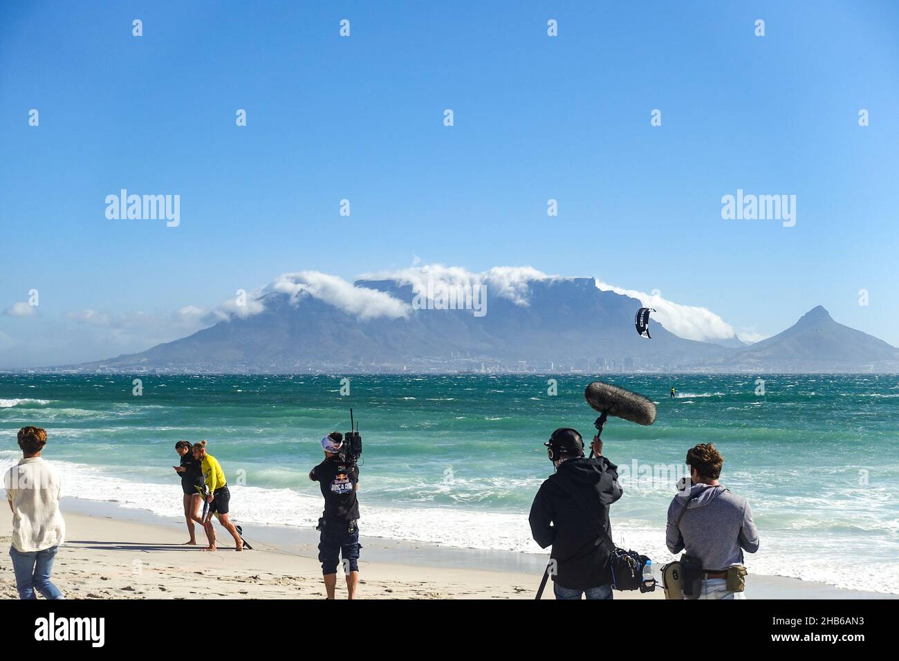 Film crew with a mic interviewing kitesurfers competing at the Red Bull King of the Air 2021 in Blouberg, Cape Town, South Africa Stock Photo