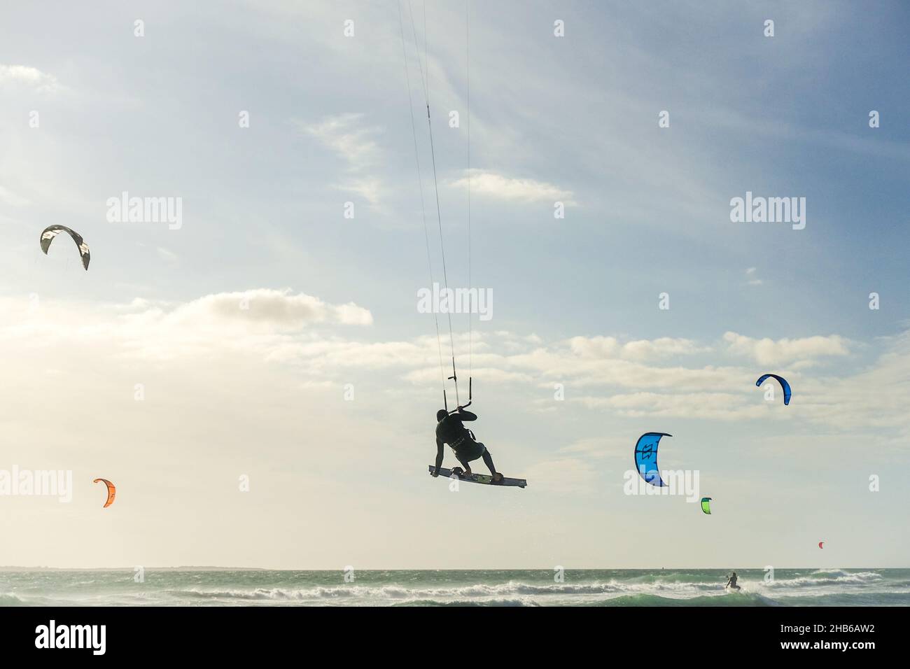 Kitesurfer performing a trick in the air while competing at the Red Bull King of the Air 2021 in Blouberg, Cape Town, South Africa Stock Photo