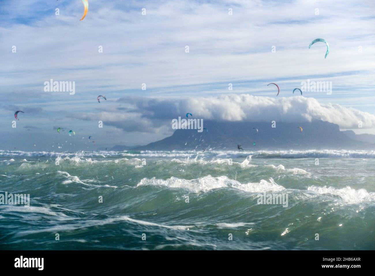Kitesurfers on rough waves in Blouberg, Cape Town, South Africa Stock Photo