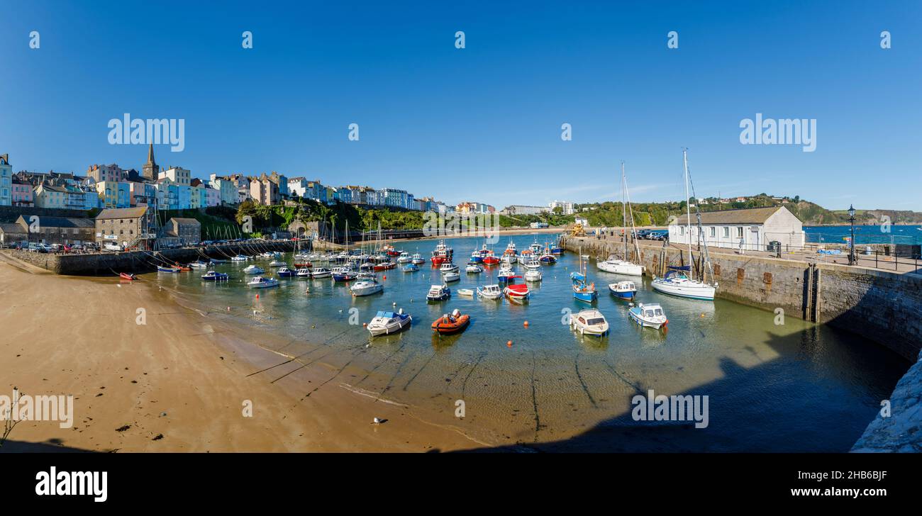 Boats moored at Harbour Beach at low tide in Tenby, a walled seaside town in Pembrokeshire, south Wales coast on the western side of Carmarthen Bay Stock Photo
