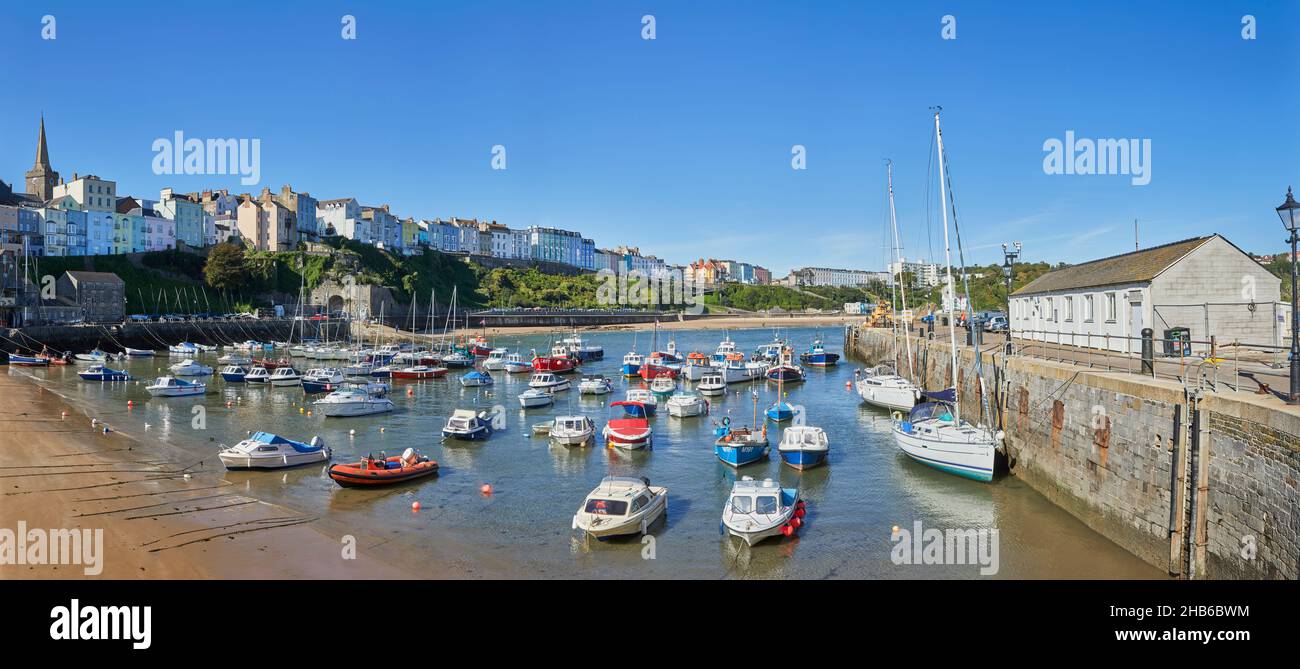 Boats moored at Harbour Beach at low tide in Tenby, a walled seaside town in Pembrokeshire, south Wales coast on the western side of Carmarthen Bay Stock Photo