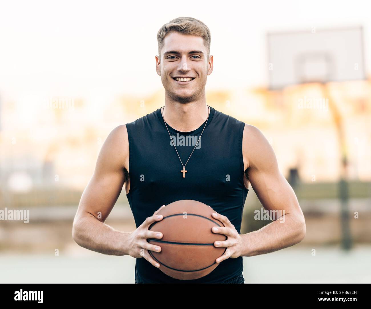 https://c8.alamy.com/comp/2HB6E2H/caucasian-athletic-man-holding-a-basketball-outdoors-2HB6E2H.jpg