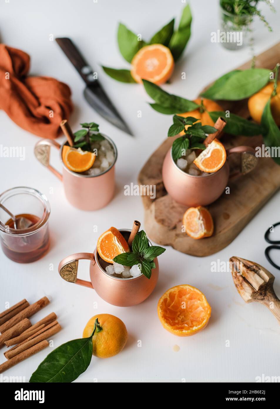 Winter tangerine and cinnamon alcohol ice cocktails with mint Stock Photo