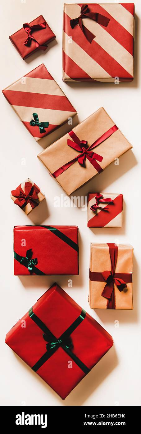 Festive gift boxes in wrapping paper for Christmas, vertical composition Stock Photo