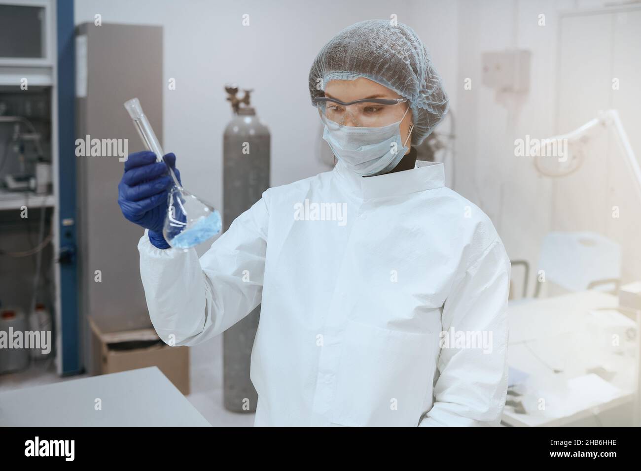Scientist or medic holding a test tube blue liquid in laboratories for the study of biochemistry. Stock Photo