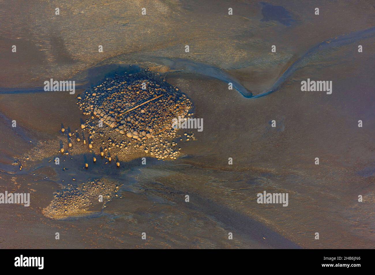 wooden beams on a stone rubble in the Elbe estuary off the island of Neuwerk, aerial view, Germany, Hamburgisches Wattenmeer National Park Stock Photo