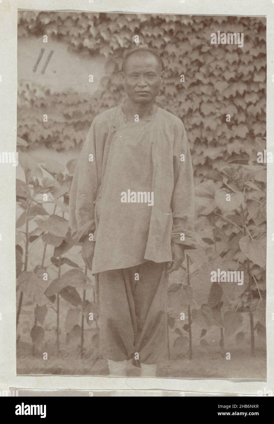 Portrait of a Chinese man in work clothes, anonymous, unknown, c. 1879 - c. 1890, paper, albumen print, height 90 mm × width 60 mmheight 345 mm × width 265 mm Stock Photo
