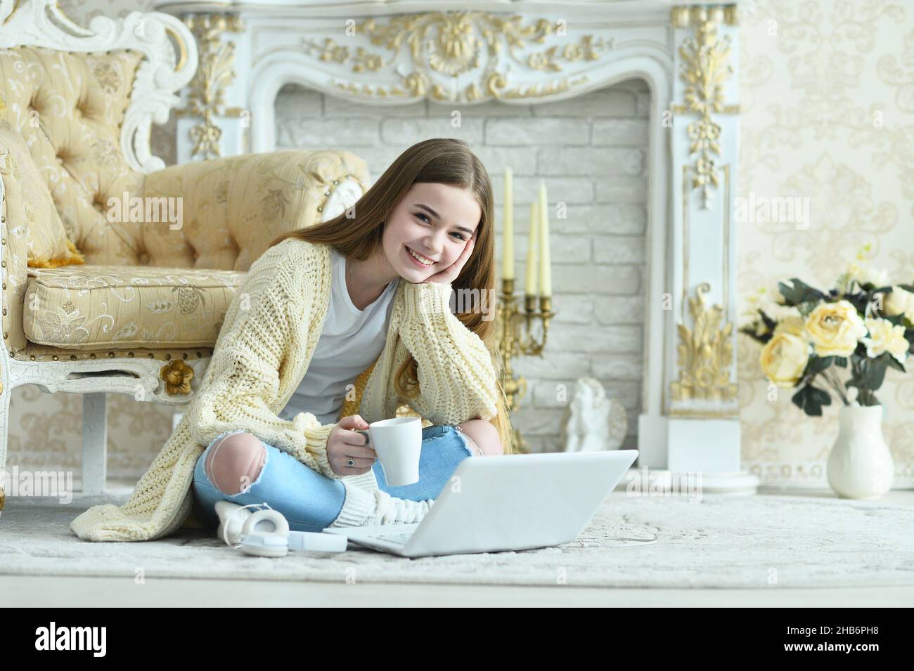 Beautiful teen girl sitting on floor near vintage armchair Stock Photo ...