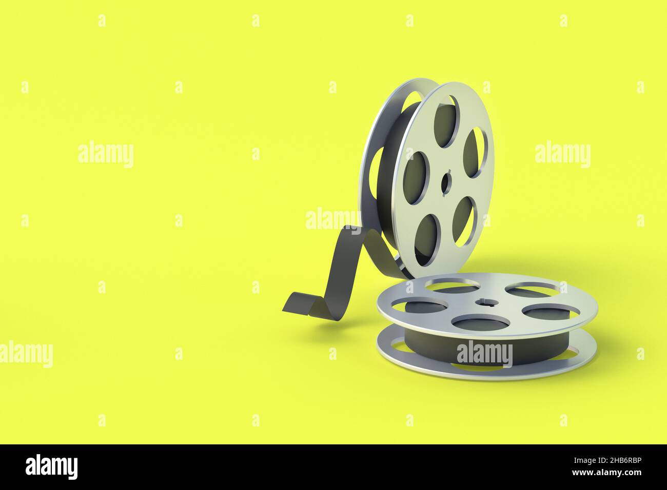 Film reel in metal frame on yellow background. Cinematography tape