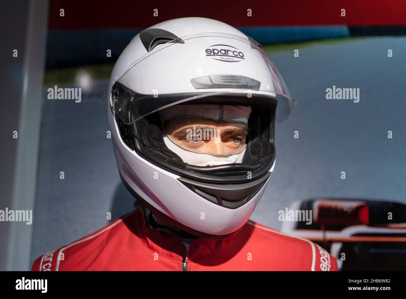 Portrait of a handsome young man wearing a racing helmet. Stock Photo