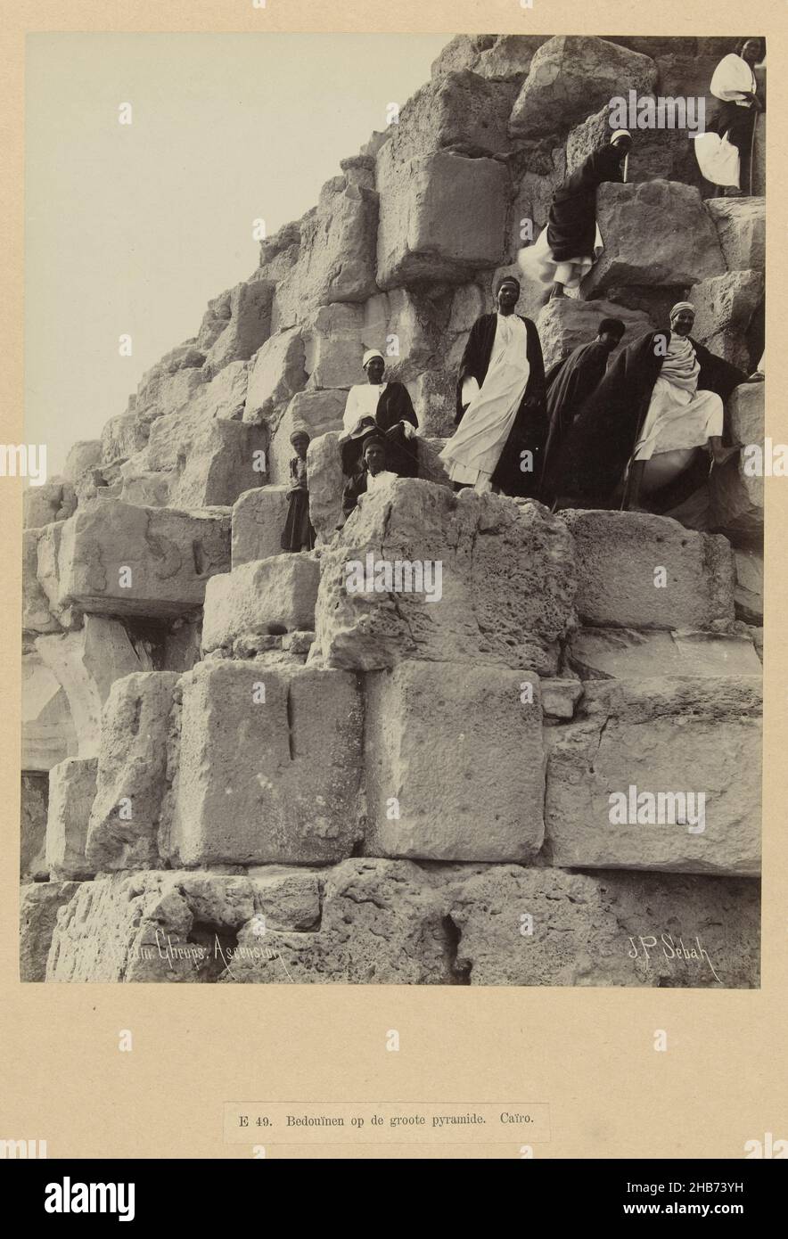 A group of men climb the pyramid of Cheops.EE 49. Bedouins on the great pyramid. Cairo (title on object), Egypt (series title)230 Pyram. Cheops Ascension (title on object), The photograph is part of the series of photographs from Egypt collected by Richard Polak., Pascal Sébah (mentioned on object), Egypte, c. 1888 - c. 1898, photographic support, paper, albumen print, height 267 mm × width 202 mmheight 557 mm × width 467 mm Stock Photo