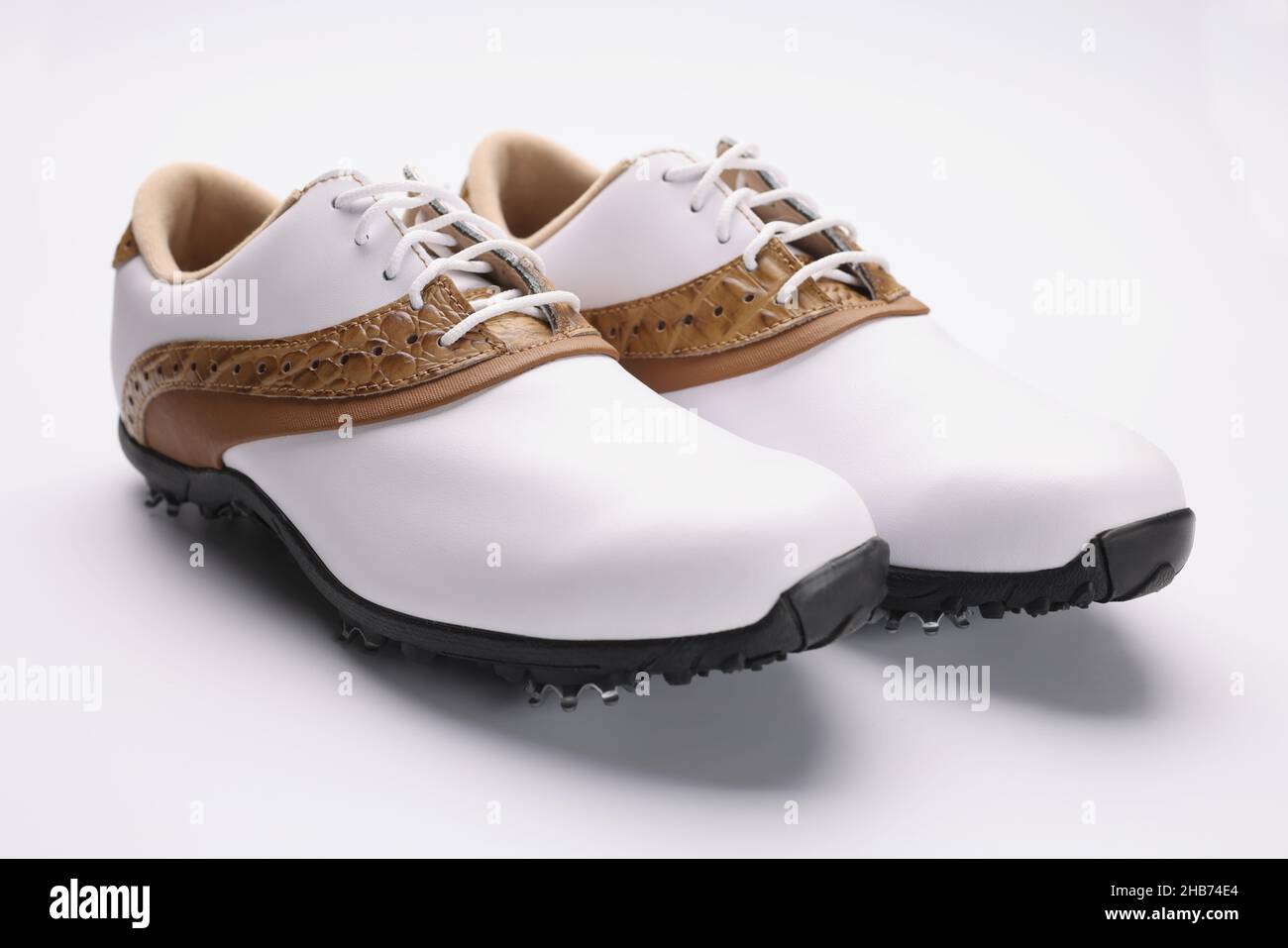 Pair of stylish fashionable shoes with unique design, white leather combines with gold Stock Photo