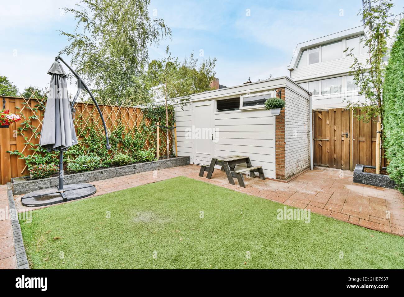 Small but cozy courtyard of the house with fresh lawn and wooden ...